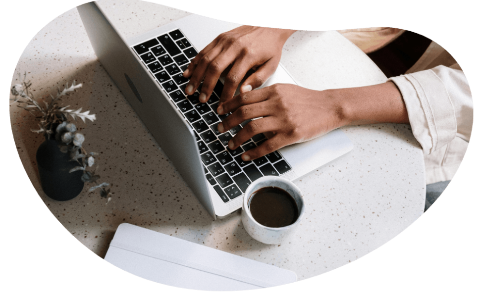 Hands typing on a laptop.